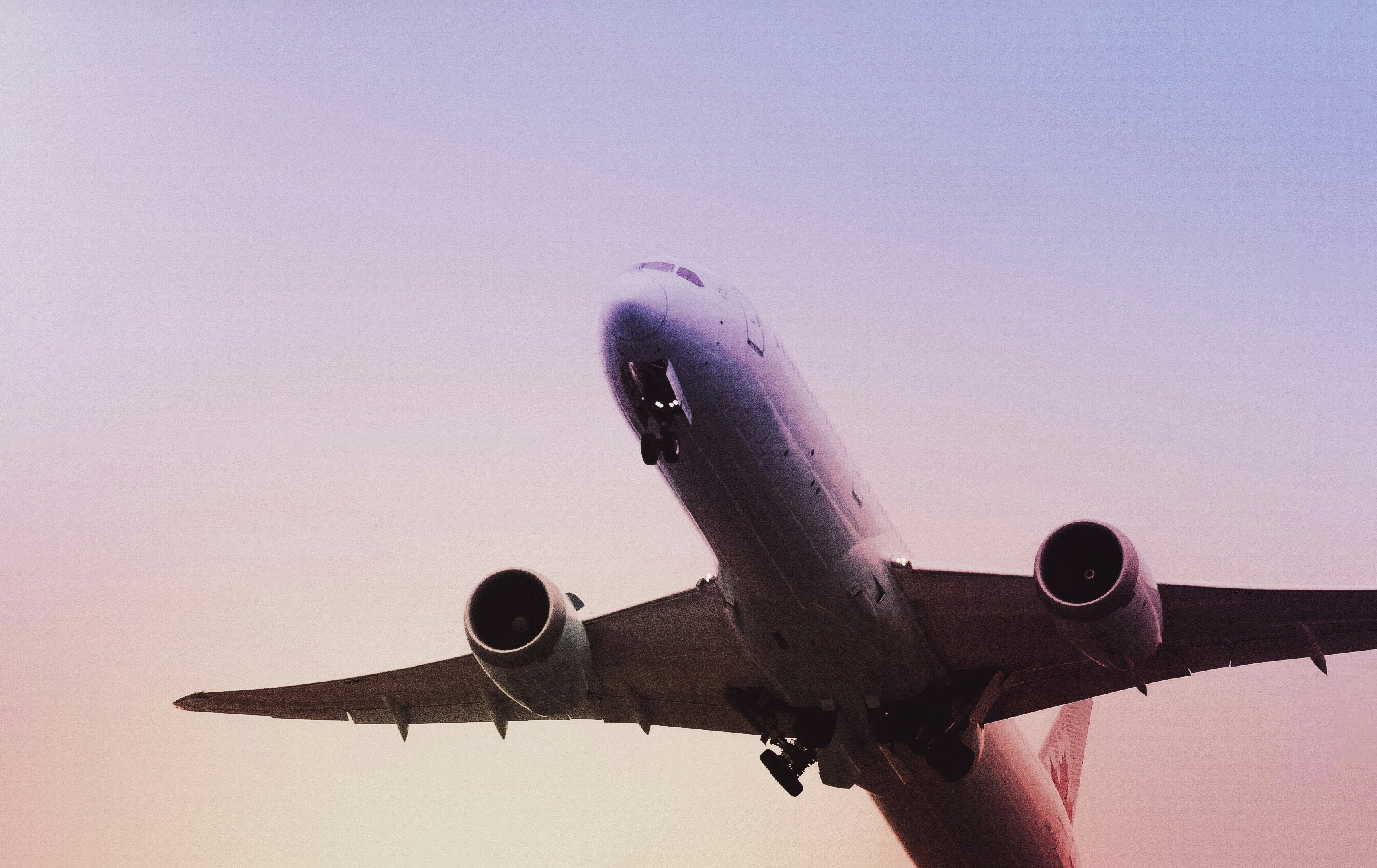 Airplane flying through a sunset sky