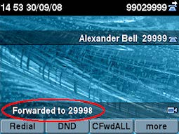 A desk phone screen showing the words ‘Forwarded to 29998’
