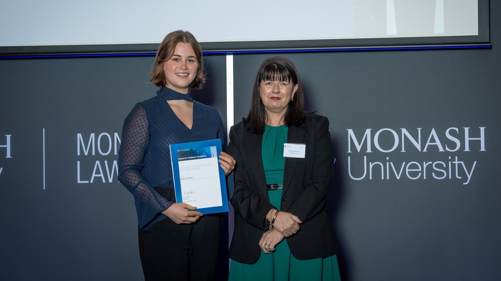 Kathryn Cawley accepts her prize from Associate Professor Becky Batagol.