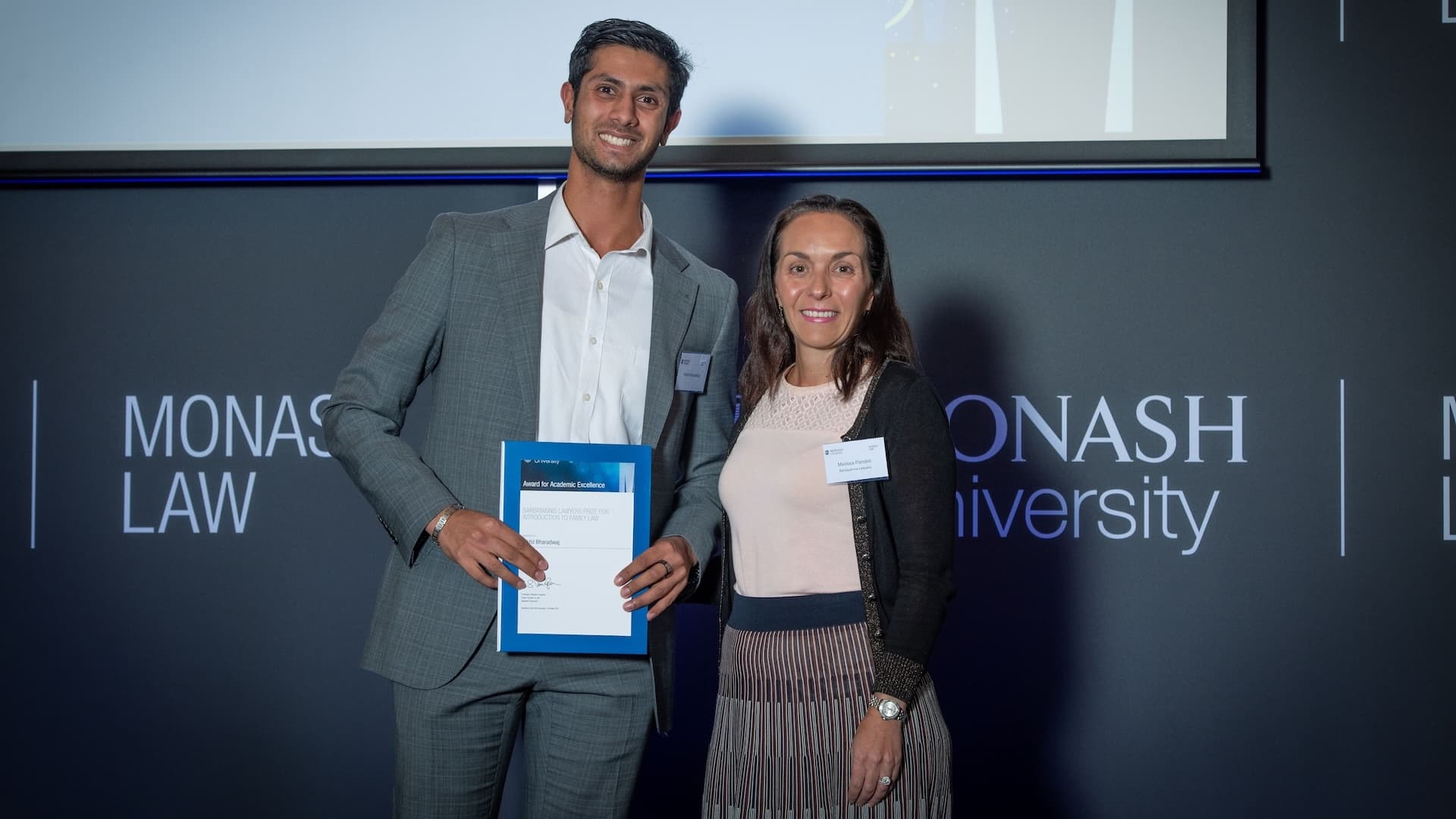 Rikhil Bharadwaj accepts his prize from Melissa Pandeli of Barbayannis Lawyers.