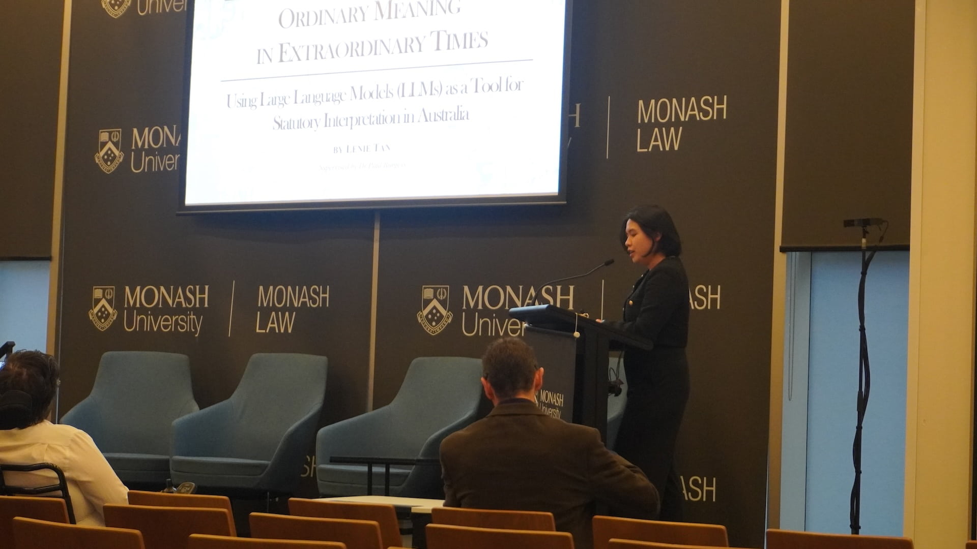 Lenie Tan speaking at a lectern