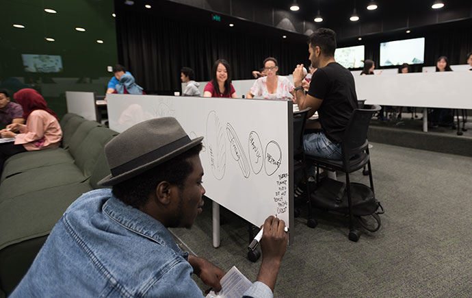 Student writes on board