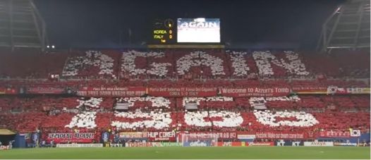 sccer2 Football fans urging on the South Korean team in the 2002 World Cup finals.
