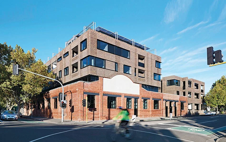 Street view of brick clad apartment building