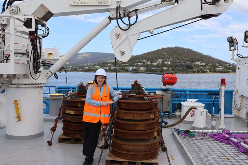 Amelia Pearson on deck with RV Investigator equipment