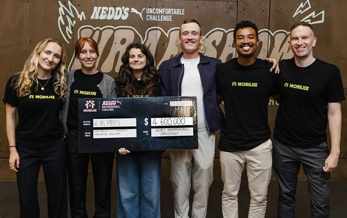Noah Yang holding a large cheque alongside Nedd Brockman.