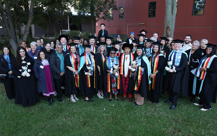 2025 Master of Indigenous Business Leadership (MoIBL) graduates with friends and family
