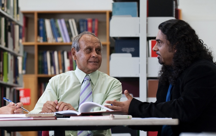 two people talking at a table in library