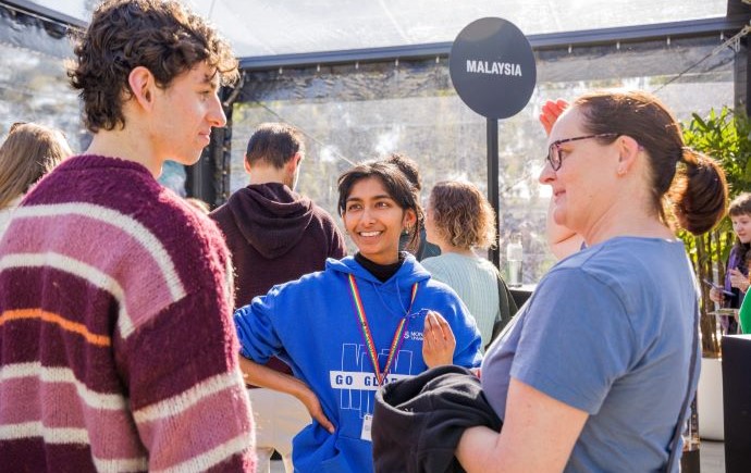 Parent talking with child and Monash ambassador at Open Day
