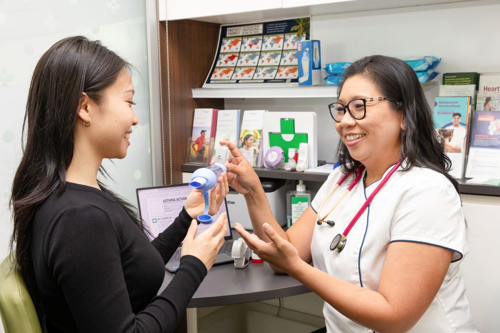 Pharmacist and patient talking over inhaler