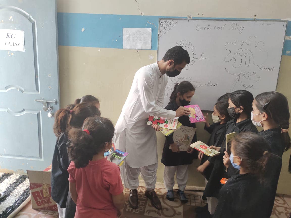 Kids getting books through the Balochistan youth action committee