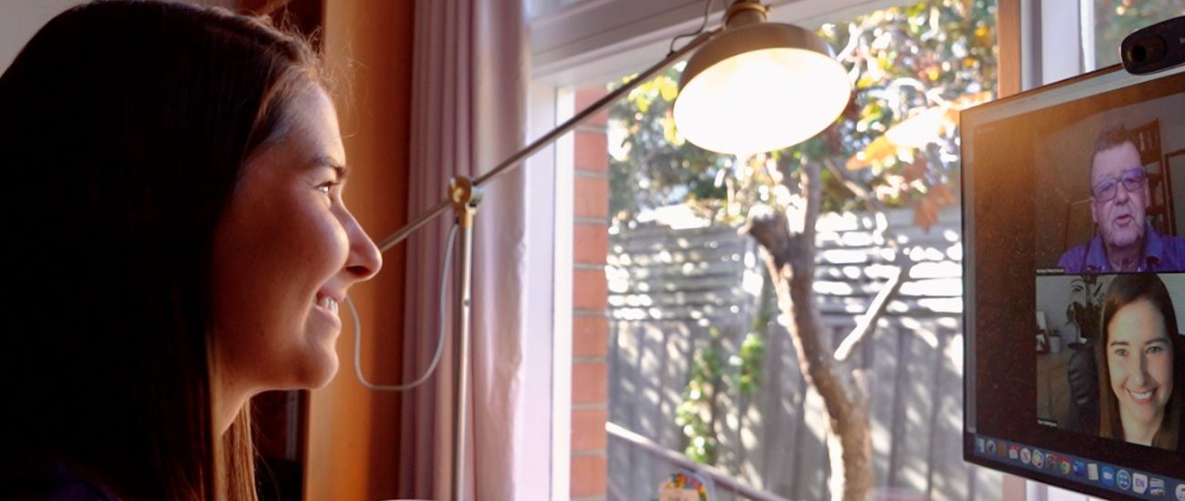 Person facing screen where others are on video call.