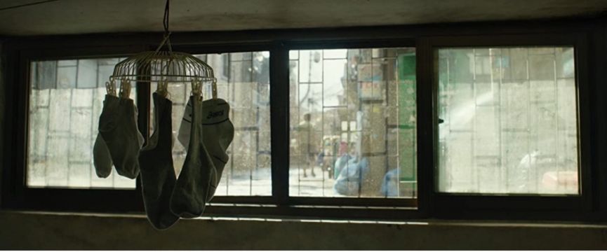 socks hanging to dry in front of a window