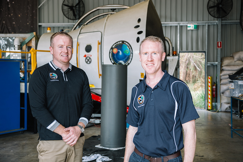 Gilmours standing in front of landing pod