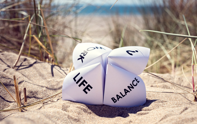 Origami fortune teller on vacation at the beach concept for work life balance choices