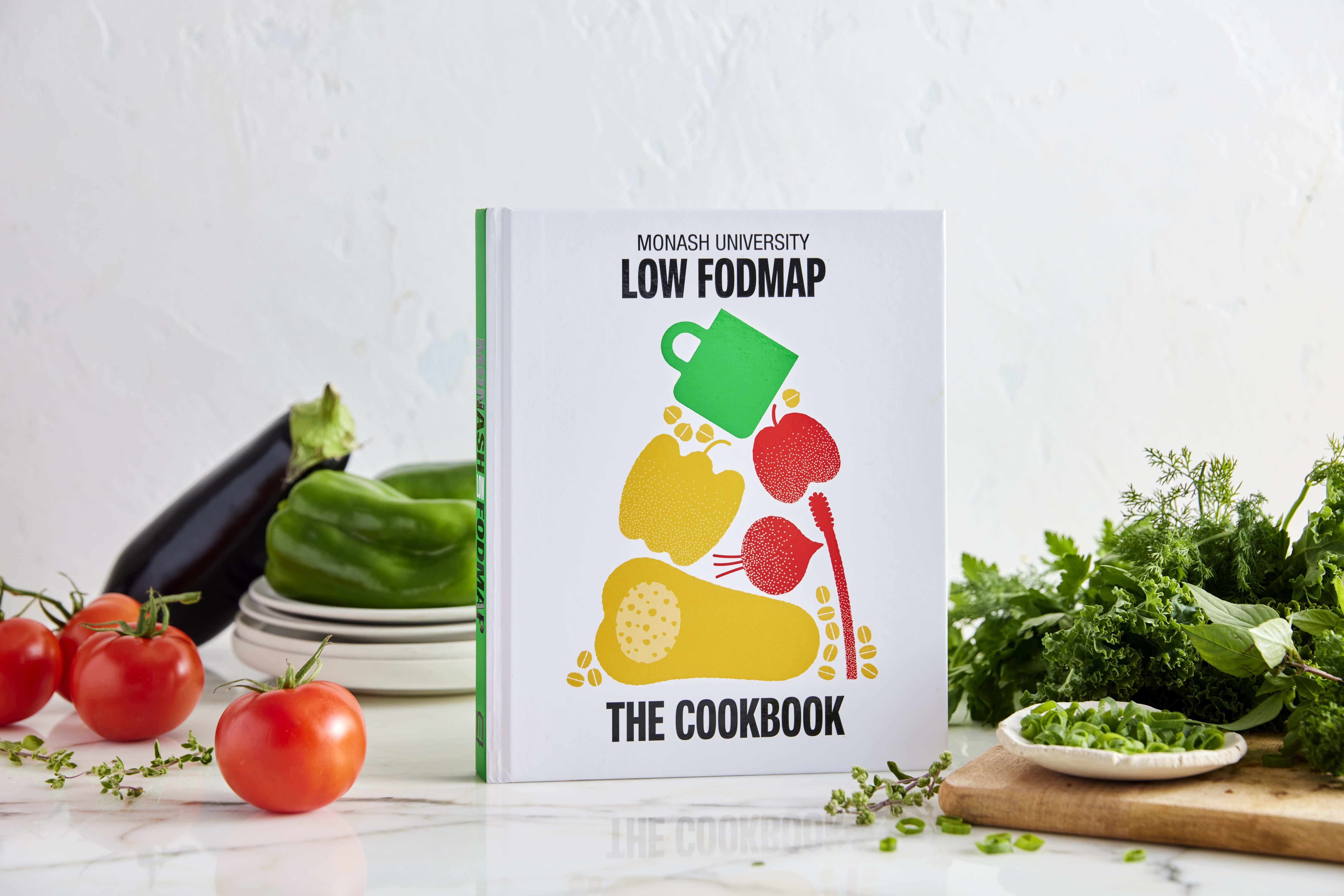 Low Fodmap Cookbook on a bench surrounded by fresh food