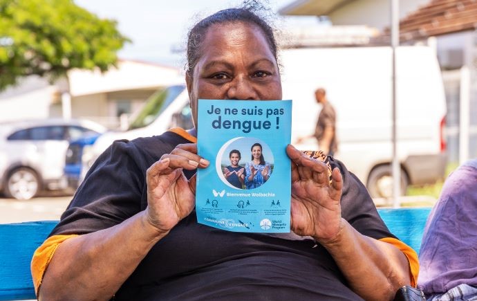 Person holding a brochure about dengue