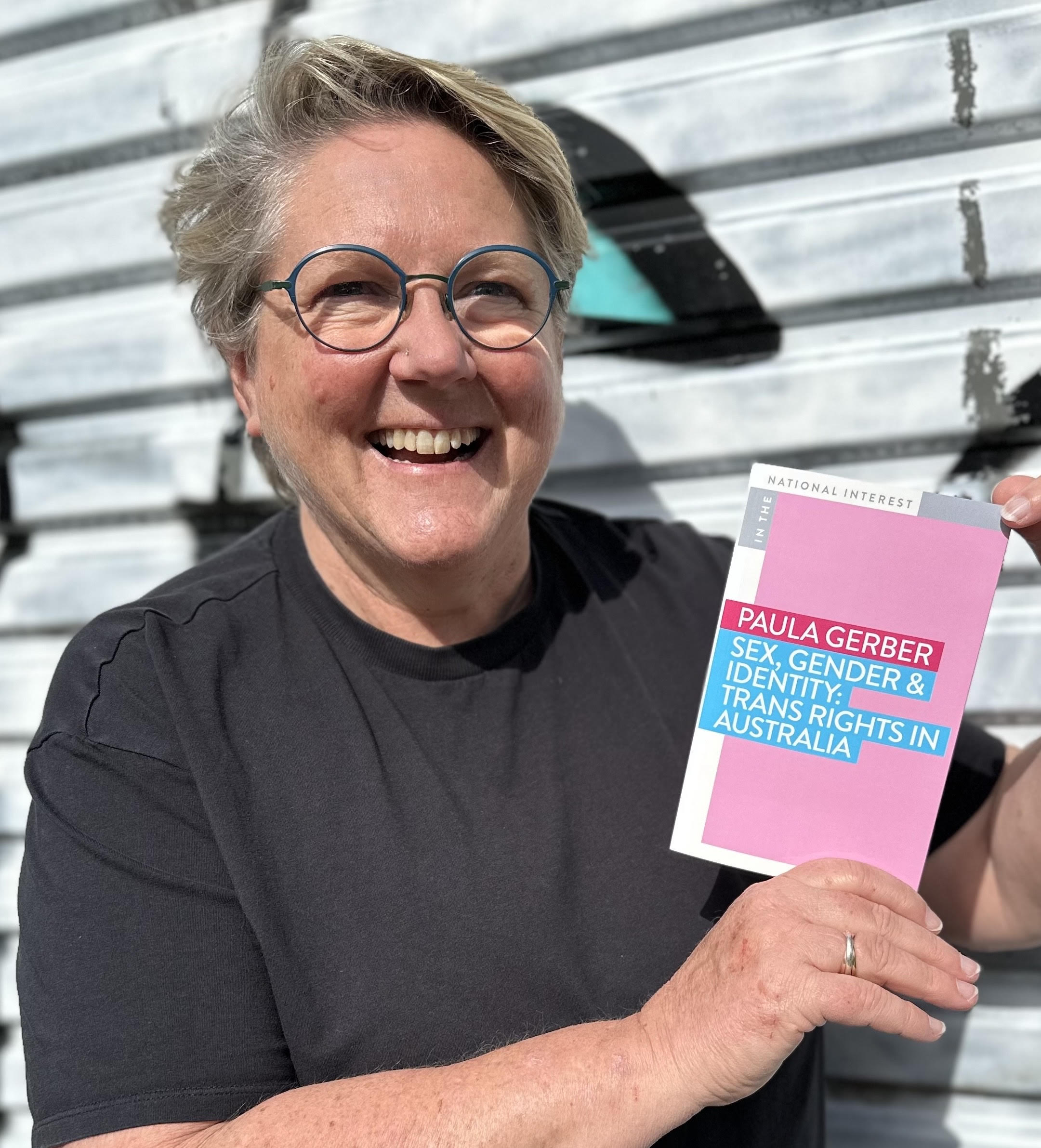Paula Gerber holding her new book. 