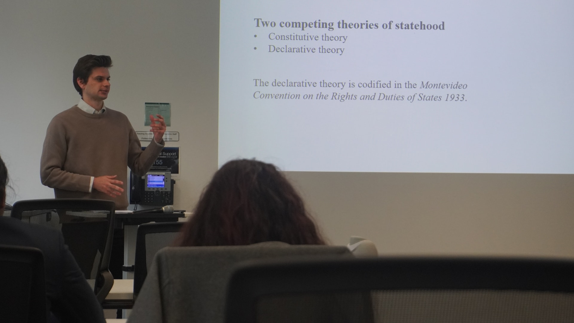 Joshua Pelach speaking at a lectern