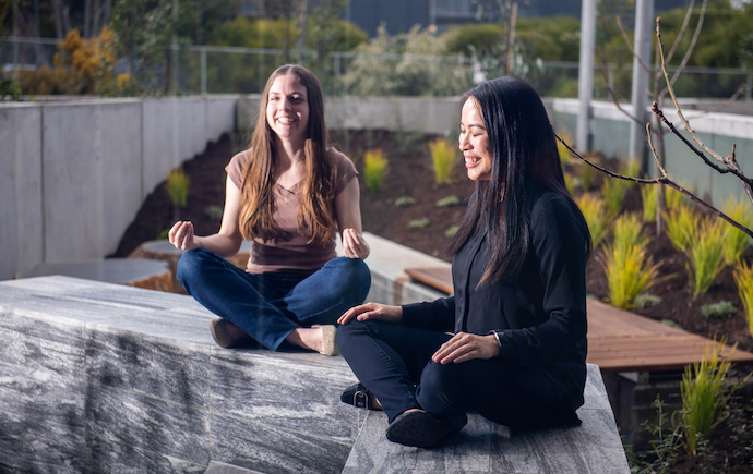 Two people meditating cross legged