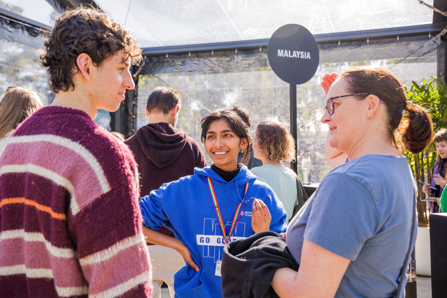 Parent talking with child and Monash ambassador at Open Day