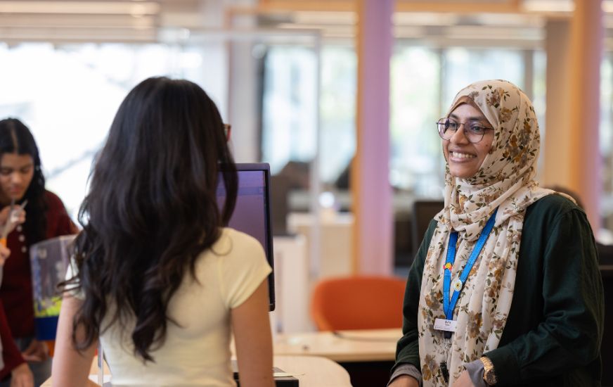 Student getting help at the library information point