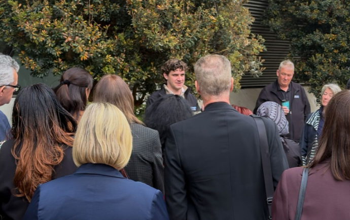 An international diplomatic delegation touring the outdoor Monash Earth Sciences Garden with researchers.