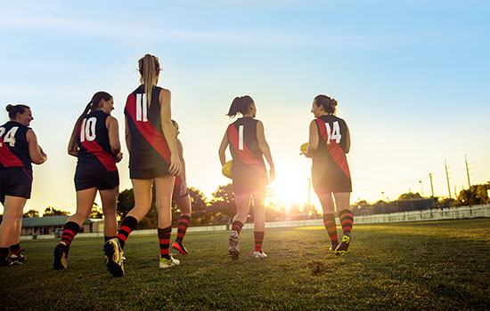 Women playing AFL football
