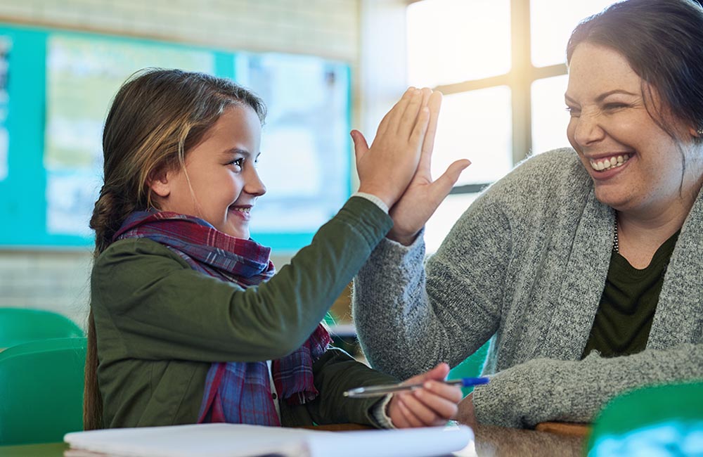 teacher encouraging a student with a high five