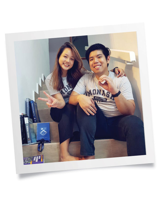 Merciana Yong and Nicholas Au Yong sitting on indoor carpeted steps