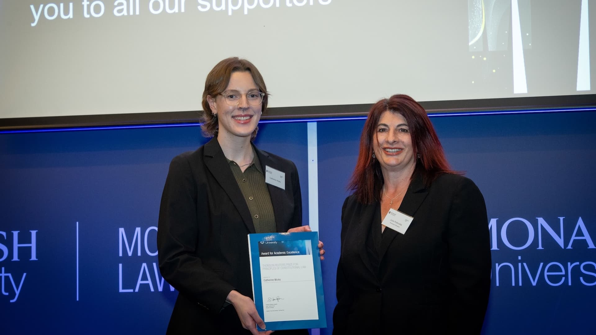 Catherine Wicks accepts her prize from Julie Petinella of Thomson Reuters.