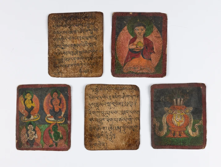 A set of five hand-painted tsakli cards, depicting scripture and meditating figures