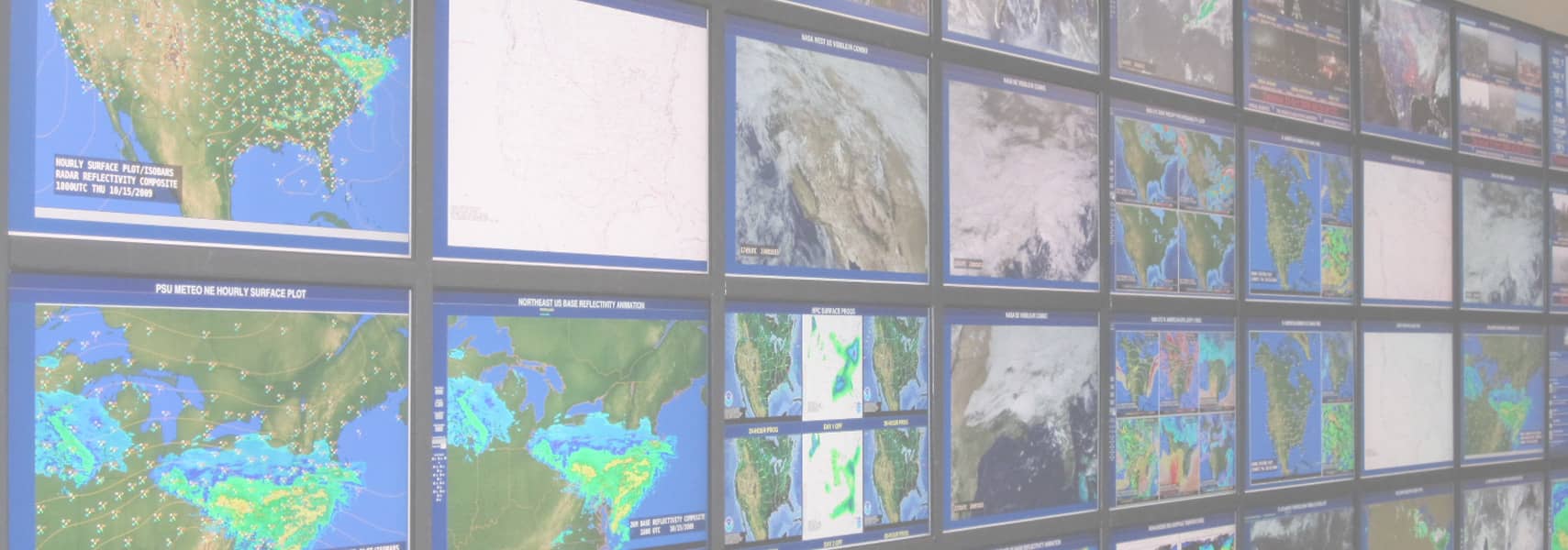 large wall of monitors displaying weather radar maps