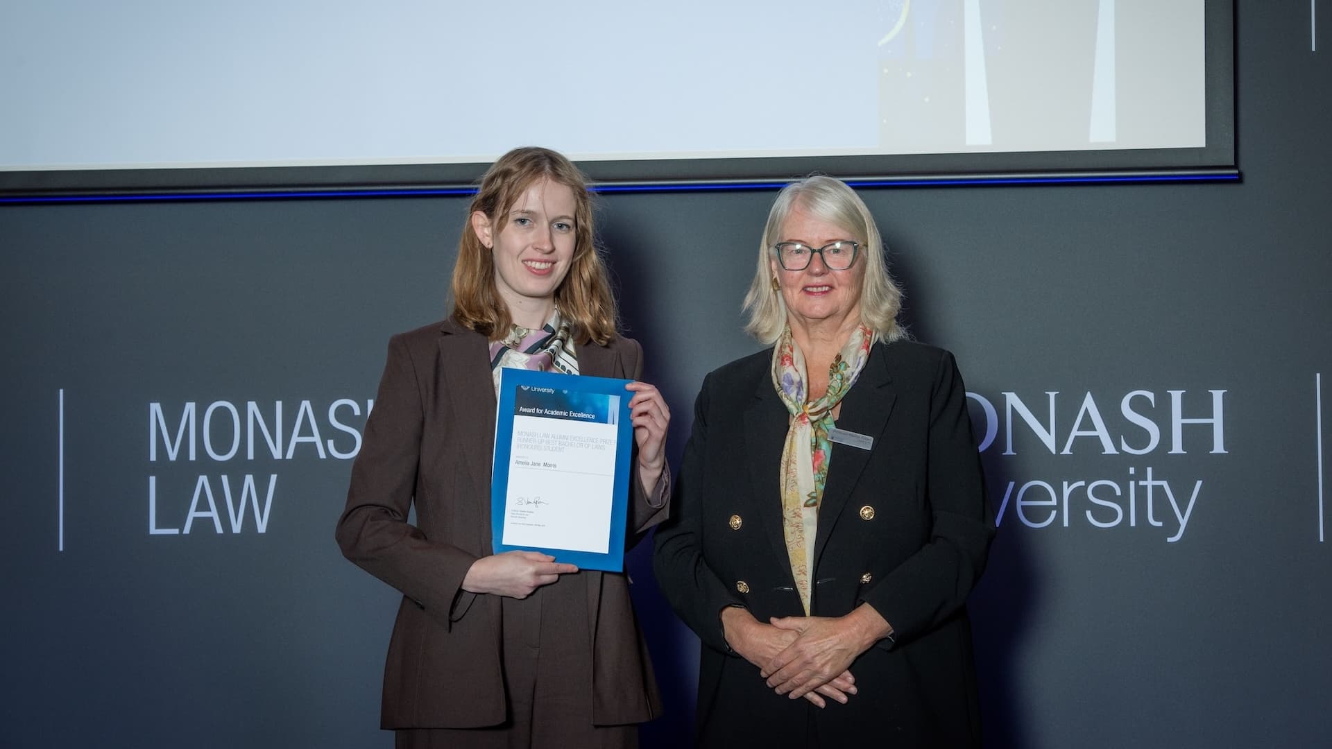Amelia Morris accepts her prize from Professor Marilyn Pittard.