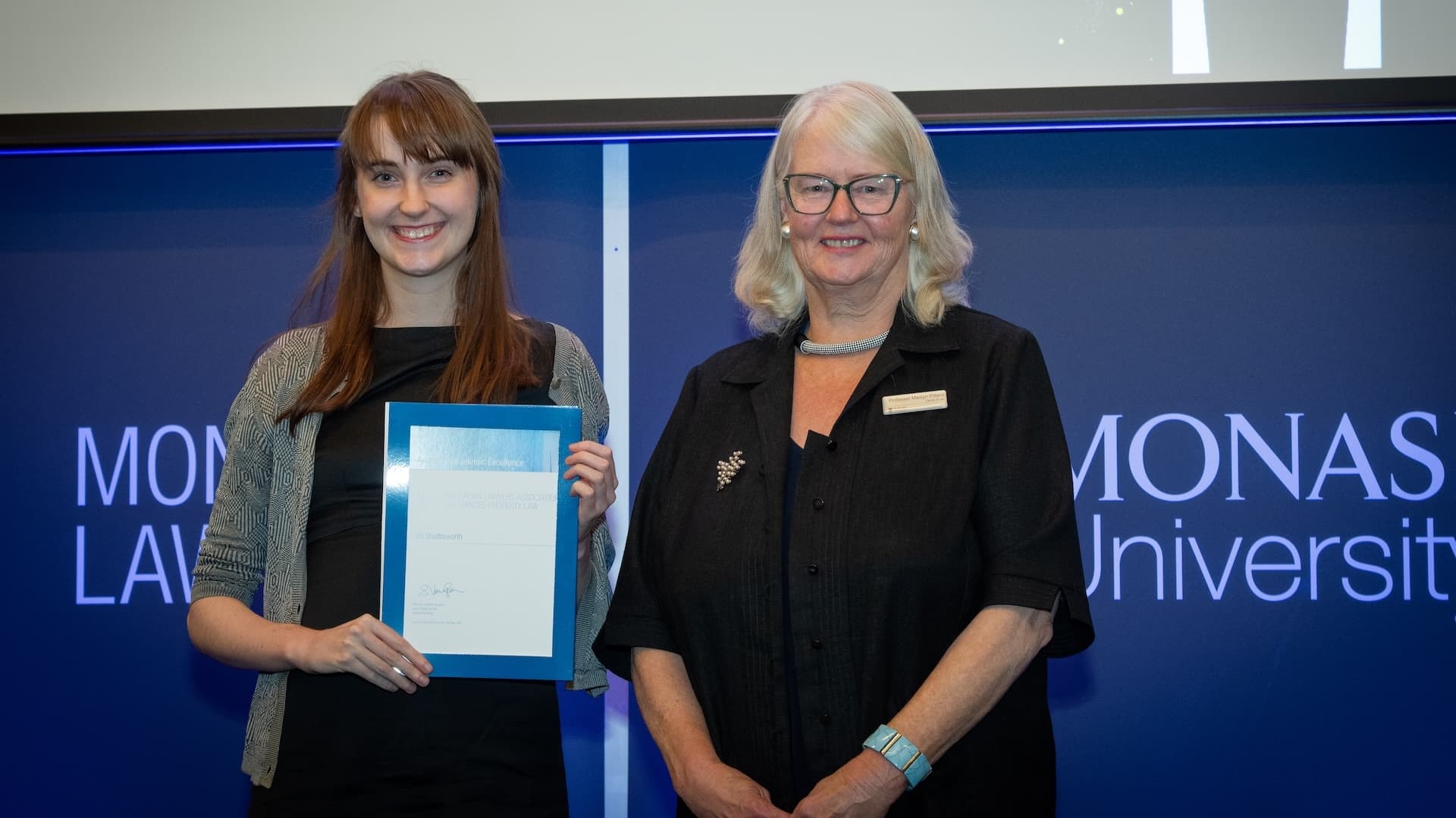 Iris Shuttleworth accepts her prize from Professor Marilyn Pittard.