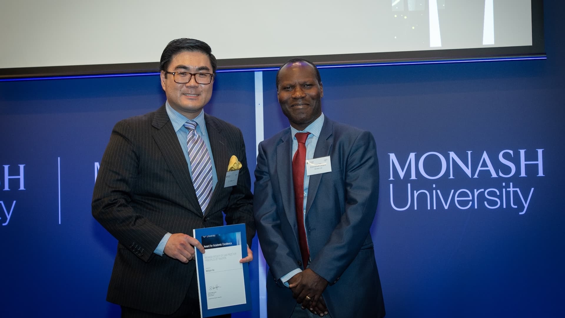 William Ho accepts his prize from Associate Professor Emmanuel Laryea.