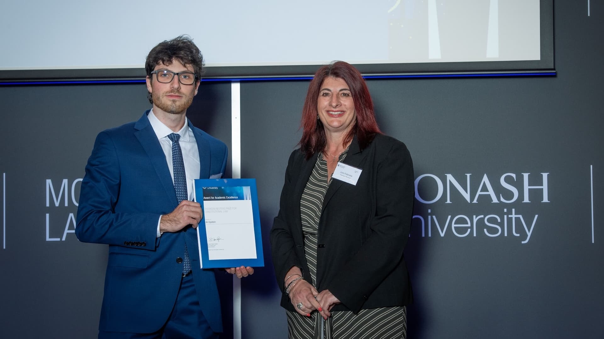 Ariel Epstein accepts his prize from Julie Petinella of Thomson Reuters.