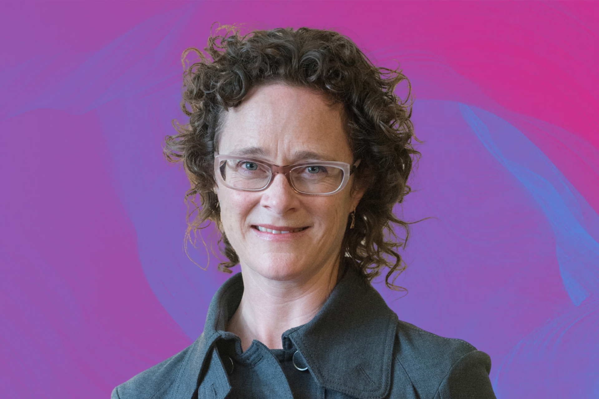 Photo of Julie Debeljak on a pink background.