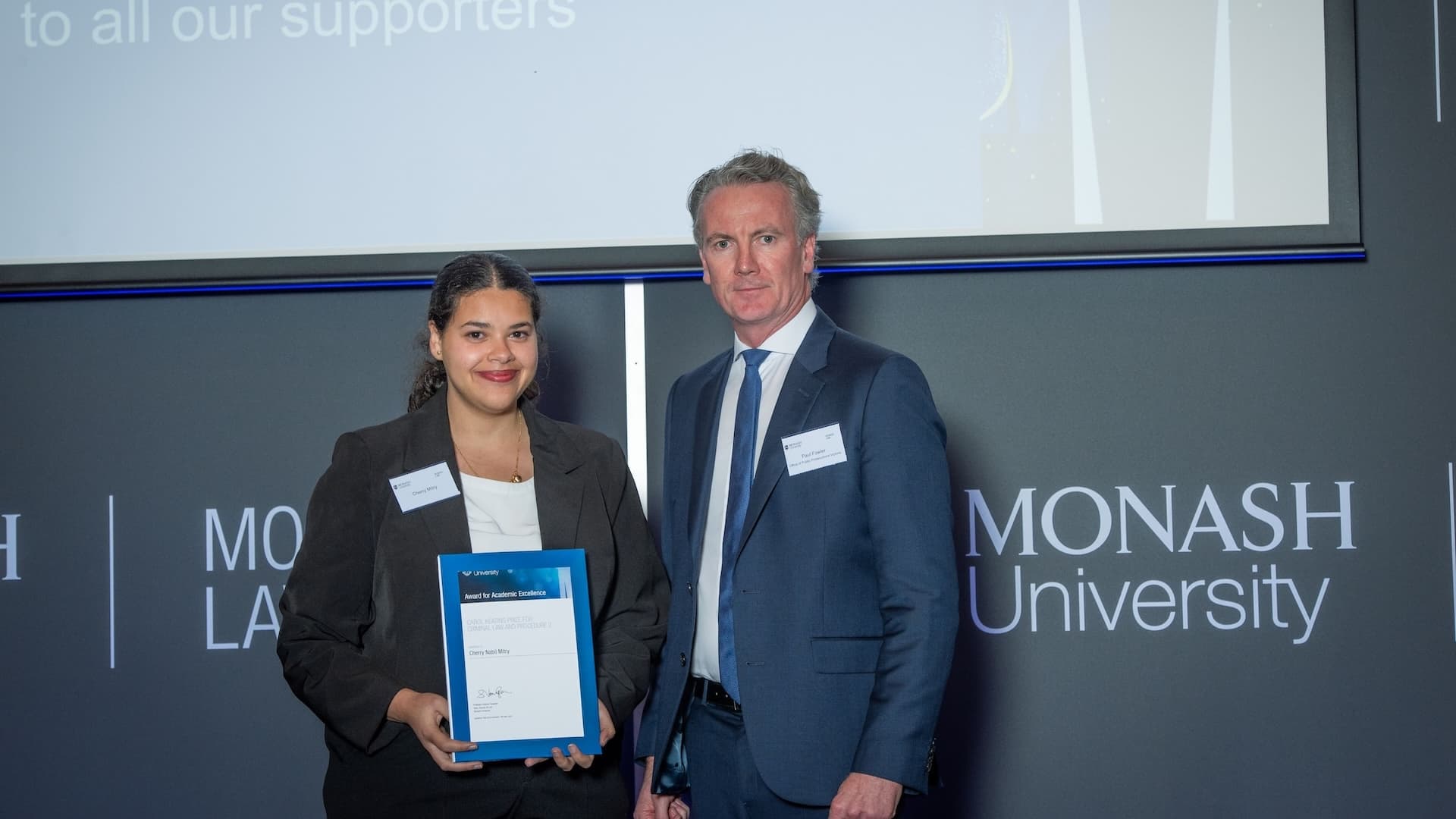 Cherry Mitry accepts her prize from Paul Fowler of the Office of Public Prosecutions Victoria.