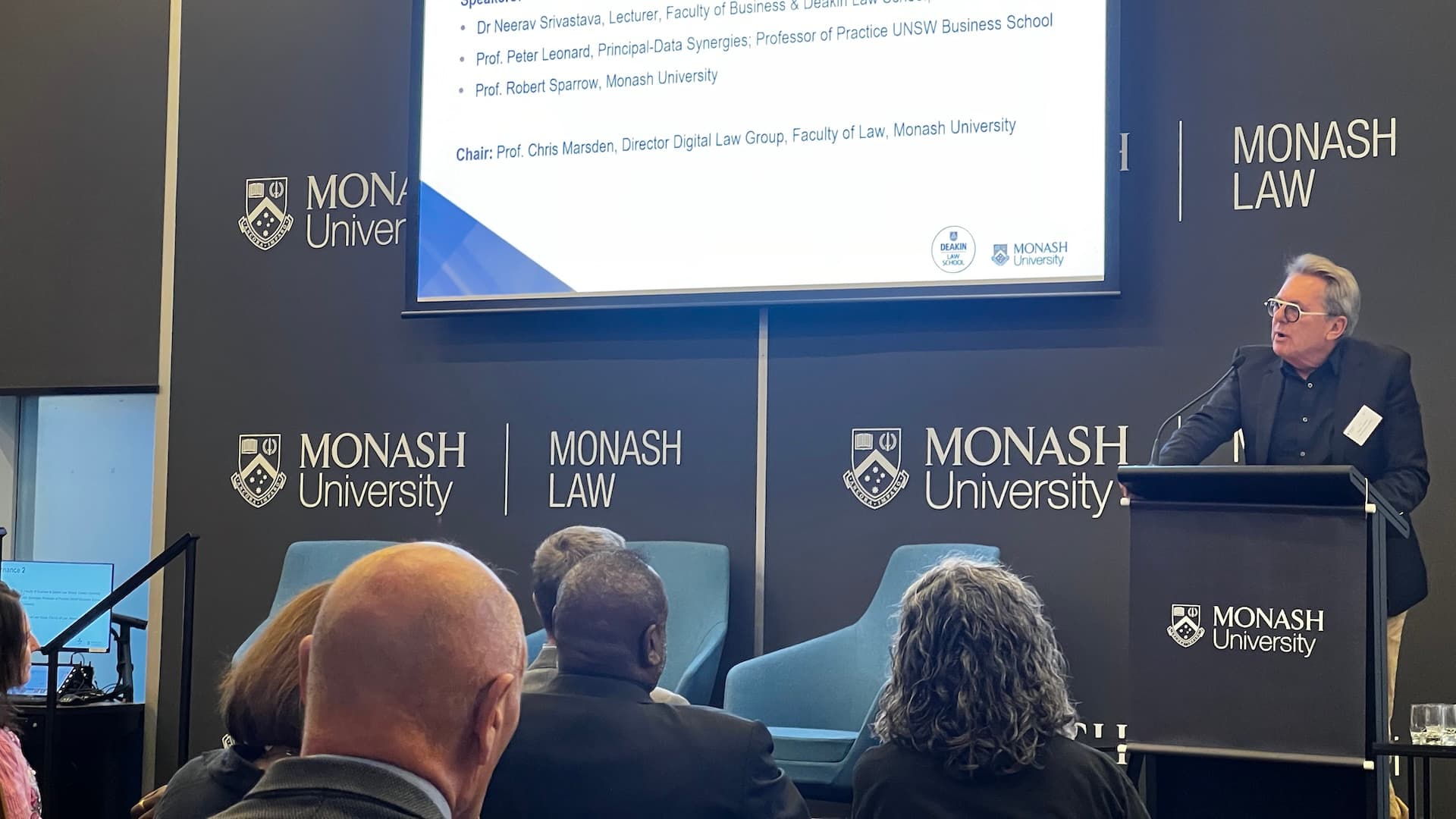 Professor Peter Leonard presenting at a lectern